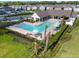 Aerial view of a community pool with lounge chairs and a shaded pavilion at 16822 Balance Cv, Land O Lakes, FL 34638
