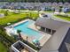 Community pool with lounge chairs and umbrellas nestled within a residential neighborhood at 16822 Balance Cv, Land O Lakes, FL 34638