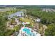 An aerial view of the community, with a pond, playground, pool, clubhouse, and green spaces at 16822 Balance Cv, Land O Lakes, FL 34638