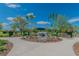 Community dog park entrance featuring a sign and well-maintained landscaping at 16822 Balance Cv, Land O Lakes, FL 34638