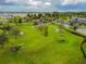 Aerial view of the community dog park, with expansive green space and play structures for pets to enjoy at 16822 Balance Cv, Land O Lakes, FL 34638