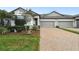 Desirable townhome with brick driveway, neatly landscaped yard, and two-car garage at 16822 Balance Cv, Land O Lakes, FL 34638