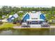 Stunning lakefront clubhouse with a covered porch and well-manicured landscaping, perfect for social gatherings at 16822 Balance Cv, Land O Lakes, FL 34638