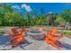 Gather around the community fire pit, surrounded by comfortable seating and lush greenery at 16822 Balance Cv, Land O Lakes, FL 34638