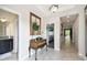 Inviting foyer showcasing tile flooring, decorative mirror, and console table at 16822 Balance Cv, Land O Lakes, FL 34638