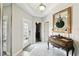 Welcoming foyer featuring tile flooring, decorative mirror and console table at 16822 Balance Cv, Land O Lakes, FL 34638