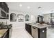 Kitchen with stainless appliances, dark cabinets, granite countertops, and open access to living spaces at 16822 Balance Cv, Land O Lakes, FL 34638
