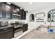Chic kitchen with stainless steel appliances, dark cabinetry, and granite countertops for a sophisticated design at 16822 Balance Cv, Land O Lakes, FL 34638