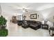 Open-concept living room and dining area featuring tile floors, modern decor, and ample natural light at 16822 Balance Cv, Land O Lakes, FL 34638