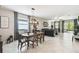 Open-concept living space with dining room, living room, and large windows, creating a bright and airy atmosphere at 16822 Balance Cv, Land O Lakes, FL 34638