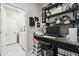 A cozy office space features black shelves and a granite countertop, offering a functional and stylish work area at 16822 Balance Cv, Land O Lakes, FL 34638