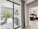 View from the home through sliding glass doors to the screened patio and Primary bedroom doorway at 16822 Balance Cv, Land O Lakes, FL 34638