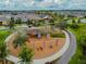 Aerial view of a community playground with slides, swings, and climbing structures at 16822 Balance Cv, Land O Lakes, FL 34638
