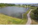 Waterfront view of a community pond with a walking path and natural landscape at 16822 Balance Cv, Land O Lakes, FL 34638