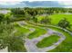 Aerial view of community pump track surrounded by lush landscaping and green spaces at 16822 Balance Cv, Land O Lakes, FL 34638
