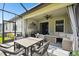 Spacious screened patio with outdoor seating, a fire table, and a view of the landscaped yard at 16822 Balance Cv, Land O Lakes, FL 34638