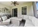 Comfortable screened patio with seating and a fire table, ideal for outdoor gatherings and relaxation at 16822 Balance Cv, Land O Lakes, FL 34638