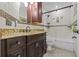 Stylish bathroom featuring a granite countertop vanity, mosaic tile accents, and a bathtub with shower at 1700 Hunter Ln, Tarpon Springs, FL 34689