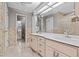 Bright bathroom features a double vanity, neutral decor, and a glass-enclosed shower at 1700 Hunter Ln, Tarpon Springs, FL 34689