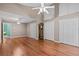 Spacious bedroom with hardwood floors, ample closet space, and two ceiling fans at 1700 Hunter Ln, Tarpon Springs, FL 34689
