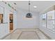 Bright dining room featuring beautiful tile floors, unique lighting, and a large window at 1700 Hunter Ln, Tarpon Springs, FL 34689