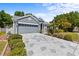 Beautiful home with well-maintained landscaping, spacious driveway, and attached garage at 1700 Hunter Ln, Tarpon Springs, FL 34689