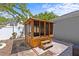 Wooden backyard gazebo sitting on a paver patio and landscaped yard at 1700 Hunter Ln, Tarpon Springs, FL 34689