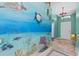 Hallway with custom undersea mural and view of the front door at 1700 Hunter Ln, Tarpon Springs, FL 34689