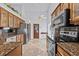 Bright kitchen with granite countertops, stainless steel appliances, and decorative tile flooring at 1700 Hunter Ln, Tarpon Springs, FL 34689