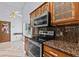 Lovely kitchen boasts stainless steel oven/microwave and beautiful granite countertops at 1700 Hunter Ln, Tarpon Springs, FL 34689