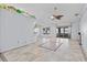 Open living room featuring tile flooring, ceiling fan, and access to outdoor space at 1700 Hunter Ln, Tarpon Springs, FL 34689