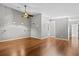 Open living room offering hardwood floors, ceiling fan, and ample natural light at 1700 Hunter Ln, Tarpon Springs, FL 34689