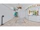 Bright living room with tile flooring, unique wall decor, and open floor plan at 1700 Hunter Ln, Tarpon Springs, FL 34689