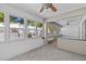 Bright sunroom with large windows offering natural light and a view of the backyard at 1700 Hunter Ln, Tarpon Springs, FL 34689