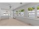 Inviting sunroom featuring tile flooring and multiple windows for ample natural light at 1700 Hunter Ln, Tarpon Springs, FL 34689