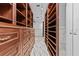 Spacious walk-in closet featuring custom wooden shelving and drawer units and stylish marble flooring at 1700 Hunter Ln, Tarpon Springs, FL 34689
