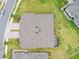 Bird's eye view of the roof, driveway, screened in lanai, backyard, and the nearby houses at 19370 Hawk Valley Dr, Tampa, FL 33647