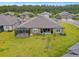 Aerial view of the backyard featuring a patio, screened in lanai, and lush lawn at 19370 Hawk Valley Dr, Tampa, FL 33647