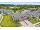 Stunning aerial view of a home featuring lush landscaping, private driveways, and a tranquil lake in the background at 19370 Hawk Valley Dr, Tampa, FL 33647