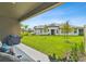 View from covered patio overlooking lawn, trees and a home with a modern design at 19370 Hawk Valley Dr, Tampa, FL 33647