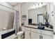 Beautiful bathroom with a large mirror, vanity, and tiled shower and tub, creating a spa-like retreat at 19370 Hawk Valley Dr, Tampa, FL 33647