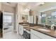 Bright bathroom features dual sinks, granite countertops and a walk-in shower at 19370 Hawk Valley Dr, Tampa, FL 33647