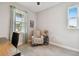 Comfortable bedroom with plush carpeting, chair, and an abundance of natural light perfect for relaxation at 19370 Hawk Valley Dr, Tampa, FL 33647