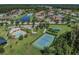 An aerial view shows a community pool, tennis court, playground, and lots of green space at 19370 Hawk Valley Dr, Tampa, FL 33647