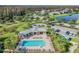 An aerial view shows a community pool, clubhouse, and plenty of lounge chairs for relaxing at 19370 Hawk Valley Dr, Tampa, FL 33647