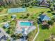 An aerial view shows a community pool, clubhouse, and plenty of lounge chairs for relaxing at 19370 Hawk Valley Dr, Tampa, FL 33647