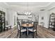 Dining room features a round wooden table, pendant lighting, and wood-look floors at 19370 Hawk Valley Dr, Tampa, FL 33647