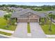Beautiful paired villas feature brick accents, well-manicured lawns, and brick paver driveways at 19370 Hawk Valley Dr, Tampa, FL 33647