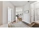 Welcoming hallway with wood flooring, white trim, and an open floor plan at 19370 Hawk Valley Dr, Tampa, FL 33647