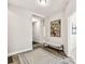 Hallway featuring hardwood floors, a plush rug, and a decorative bench creating an inviting space at 19370 Hawk Valley Dr, Tampa, FL 33647